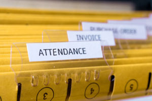 photo of yellow file folders with the word attendance attached to the top folder