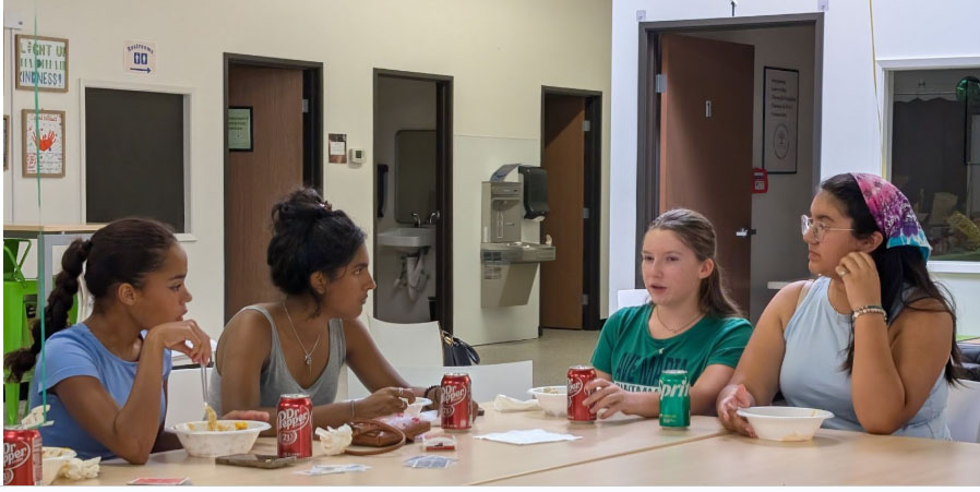 four students sitting at a table