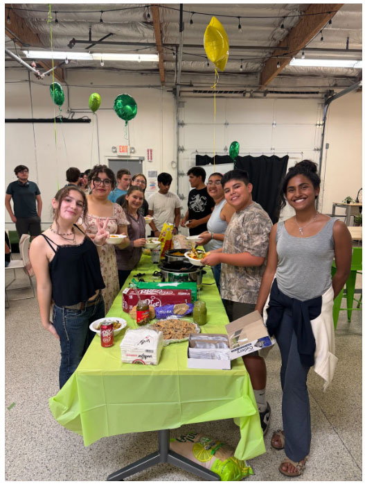 students on the Teen Leadership Committee standing around a table