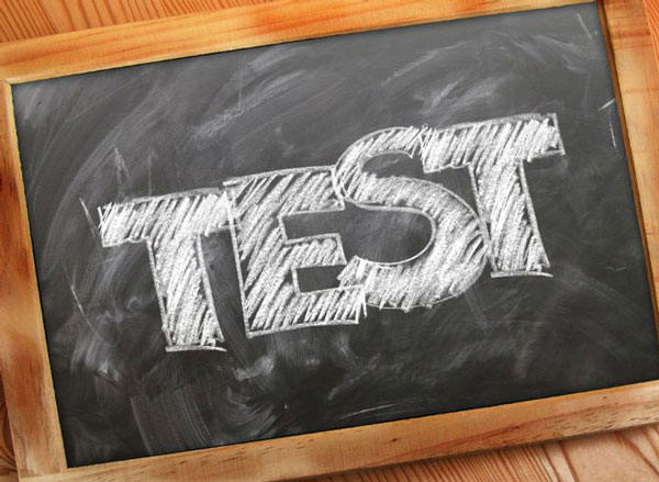 small chalkboard in a wooden frame with the word TEST written in white chalk<br />
