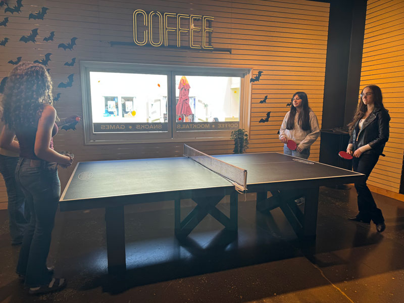 students at October TLC meeting playing ping pong