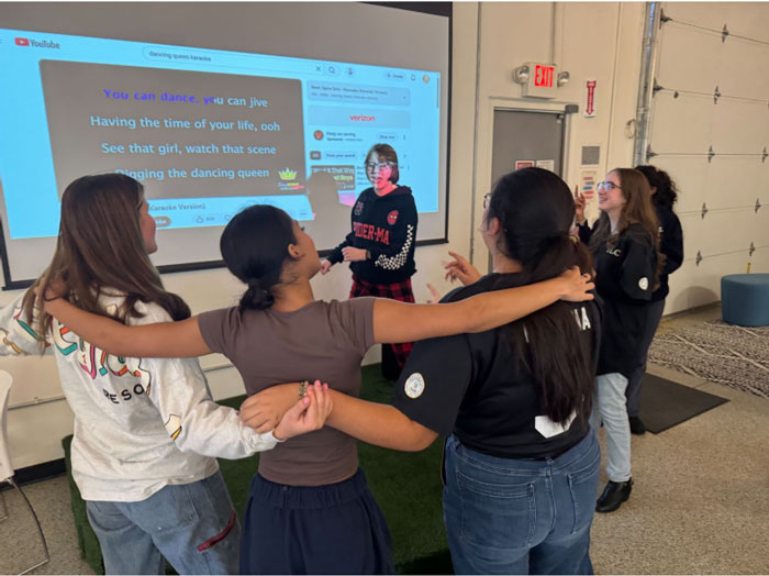 students singing karaoke at the january tlc meeting