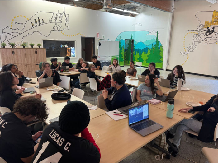 students sitting around tables at the january tlc meeting
